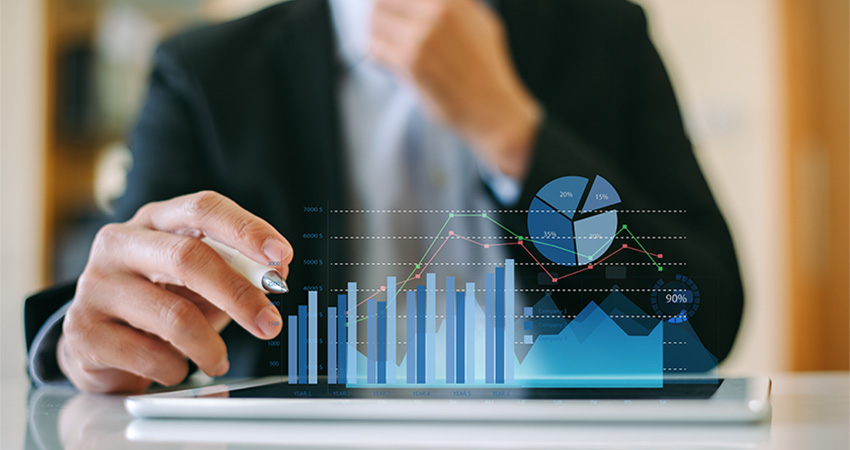 Healthcare professional looking at workforce management analytics on a tablet
