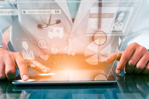 A doctor in a white coat uses a touchscreen tablet with digital medical icons, graphs, Real World Data, and health insurance information projected as holograms.