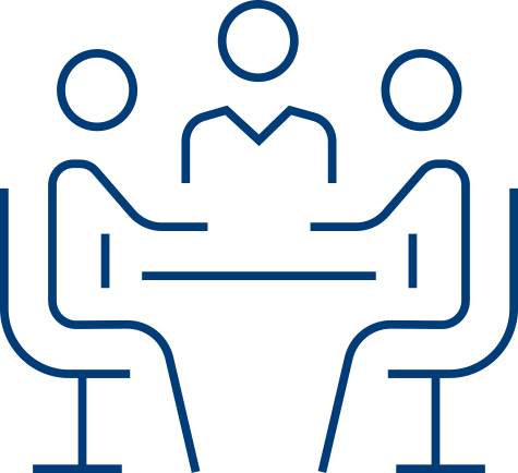 Simple line drawing of three people sitting at a table, with two on one side facing one person on the other, suggesting a RADV audits meeting, interview, or discussion.