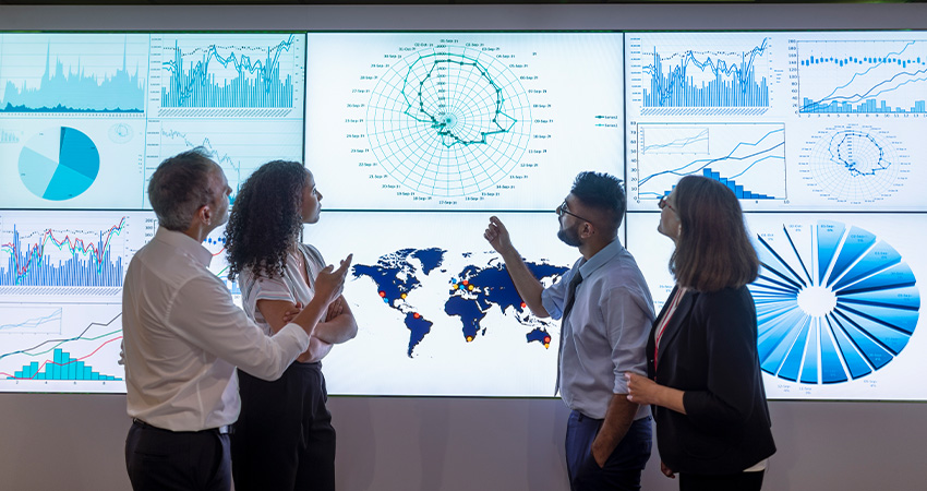 People reviewing data on a screen.