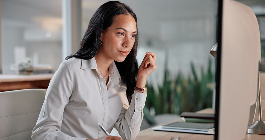 A woman is working at her desk.