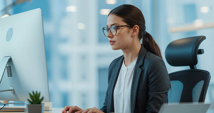 Woman in an office using a computer.