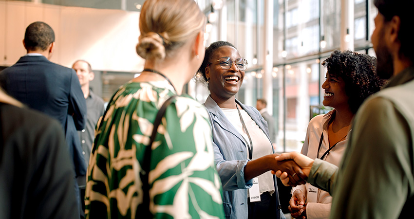 healthcare professionals meeting and smiling at a conference