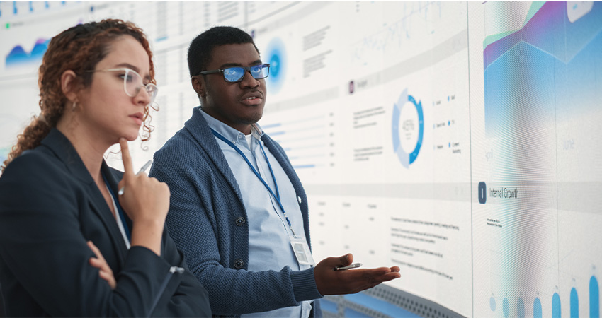 Two people analyzing data