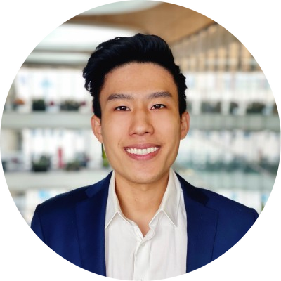 Anthony Yu headshot - man with long black hair smiling for headshot in a blue blazer