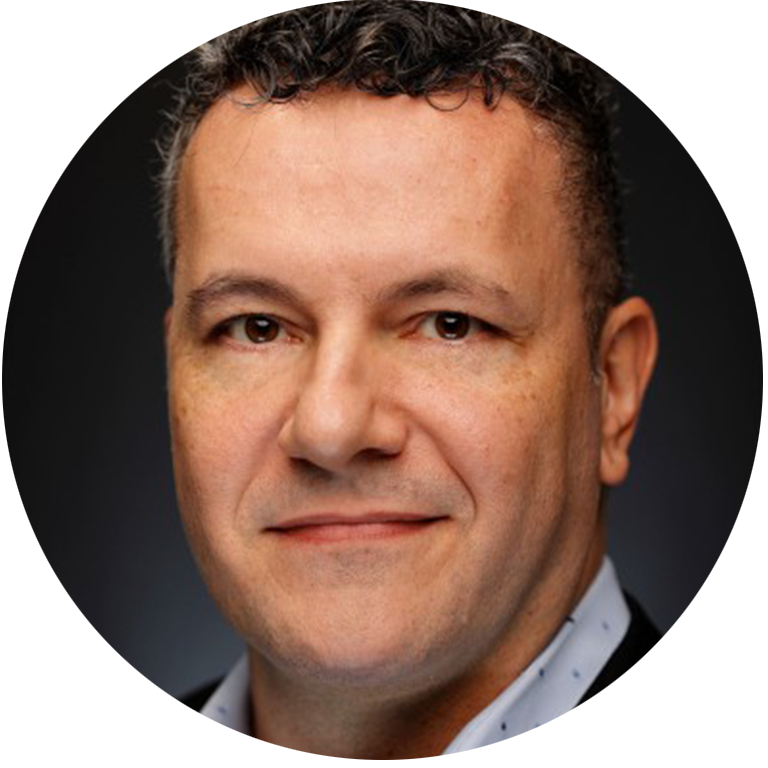 Man with dark curly hair smiling for headshot
