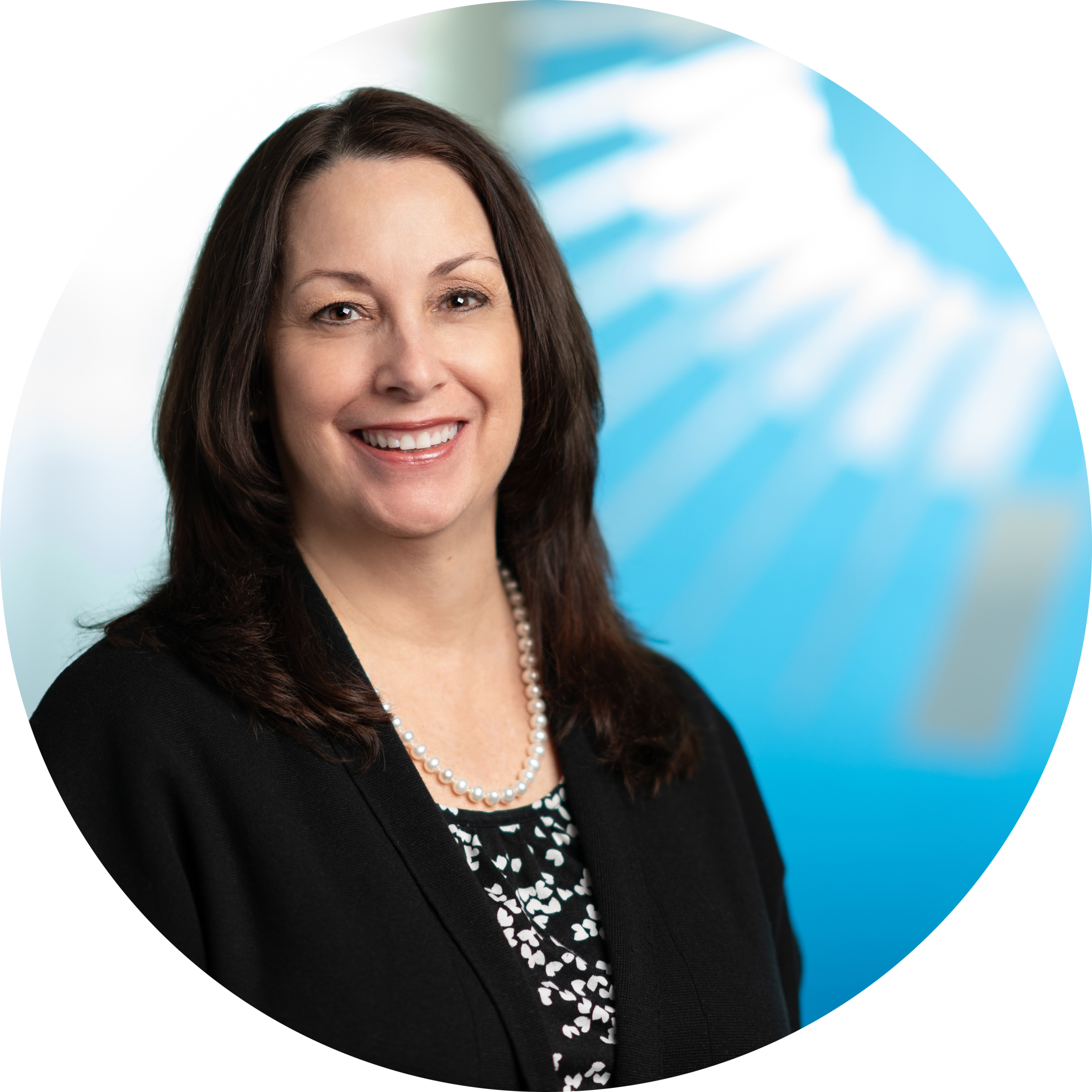 Donna McMorrow headshot - woman with mid-length dark hair in a black blazer smiling for her headshot