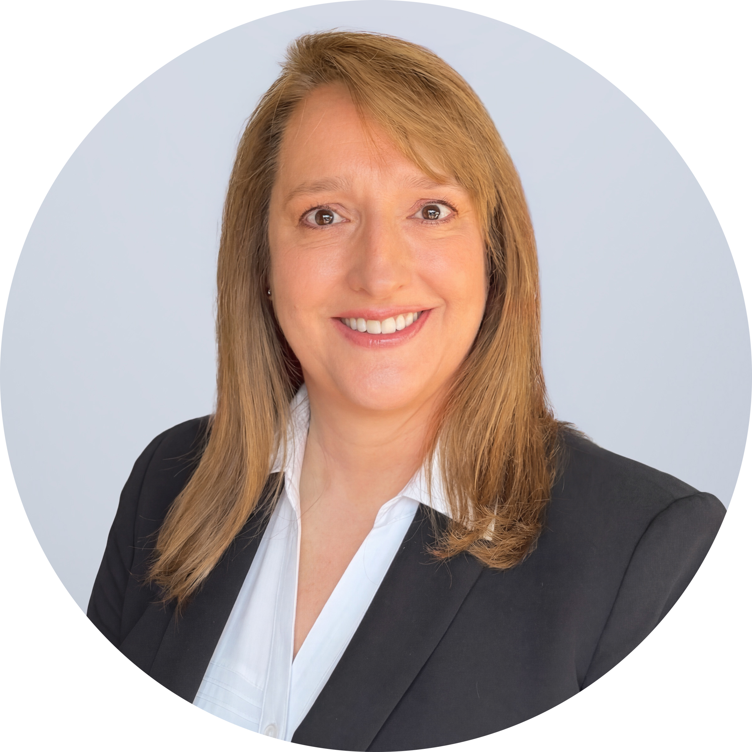 Laura Greene headshot - woman with light brown midlength hair smiling for headshot in a black blazer