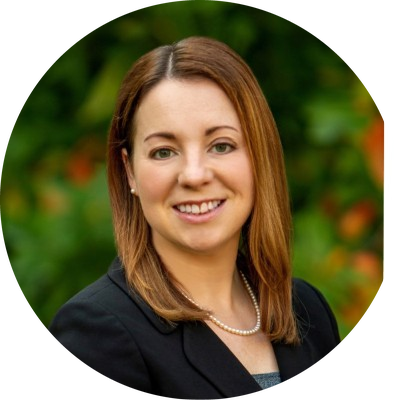 Laura Moore-Schiltz, Ph.D., RDN headshot - woman with mid-length hair smiling for headshot in a black blazer