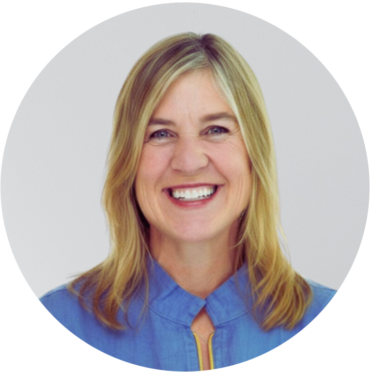 Paige Kilian headshot - woman with blonde hair smiling for headshot in a blue shirt