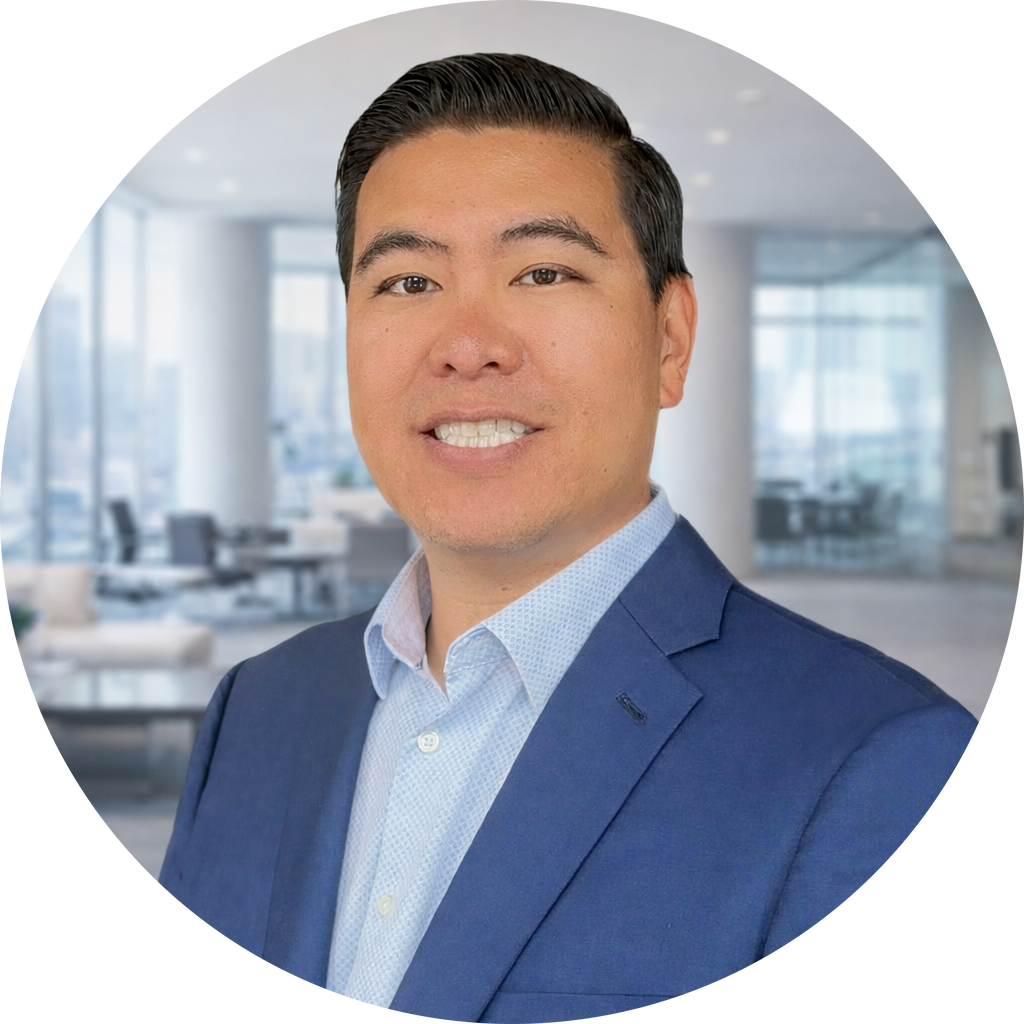Philip Chan - man with dark hair smiling for headshot in a blue suit